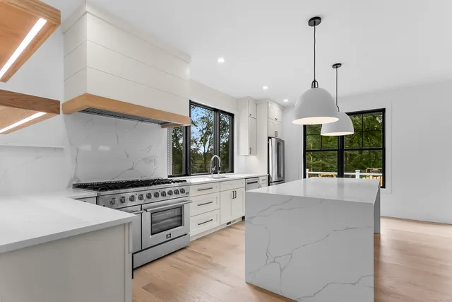 a kitchen with stainless steel appliances granite countertop a stove and a sink