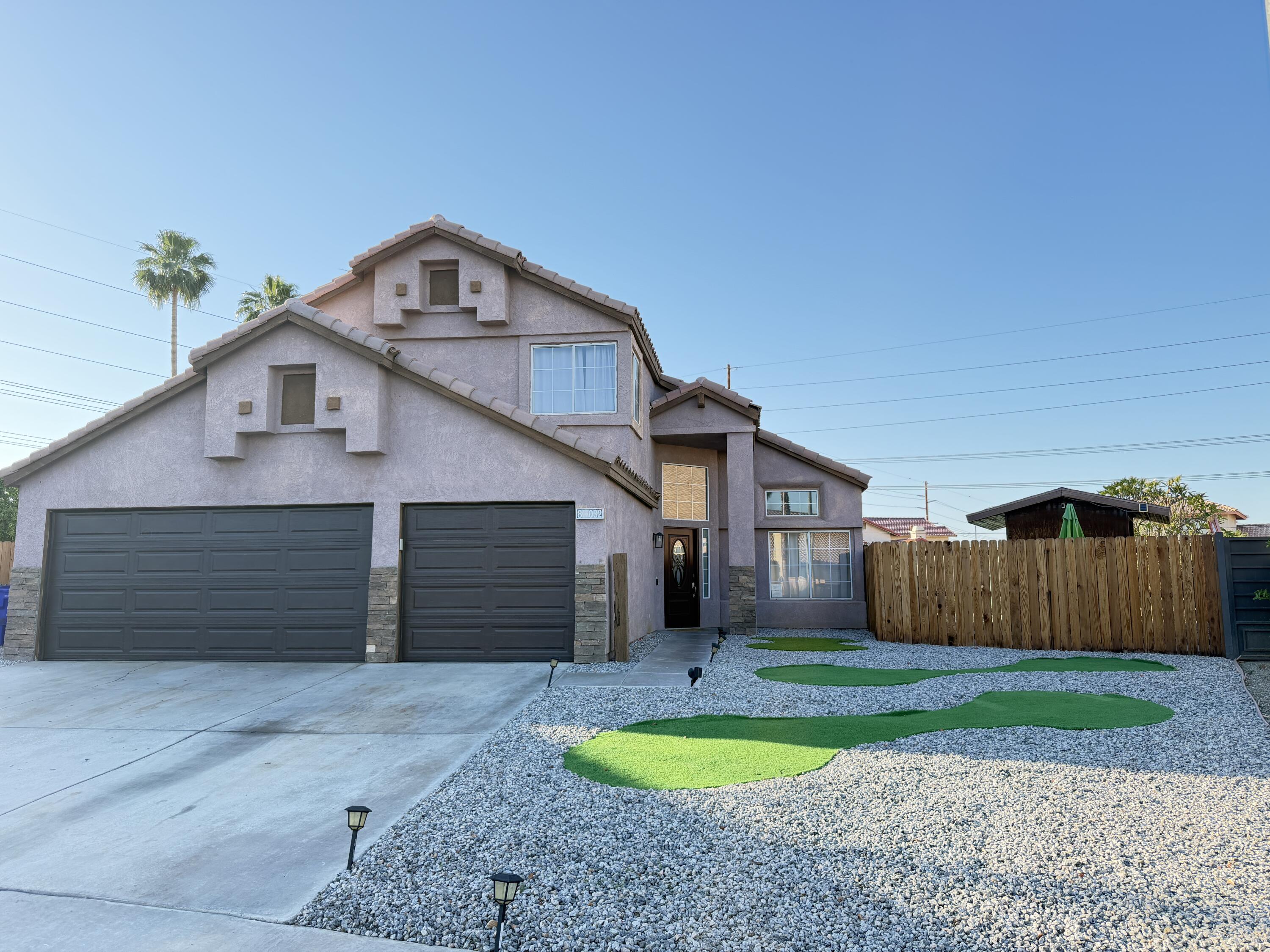 81032 Red Bluff Road Indio, CA 92201 - Photo 32 of 33 a front view of a house with yard and garage