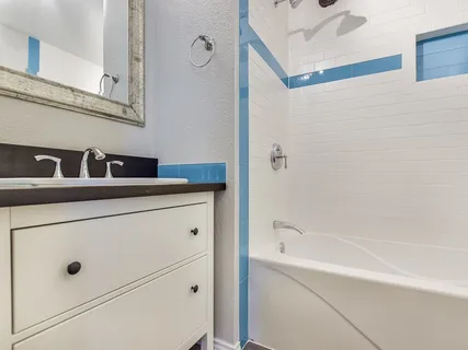 a bathroom with a bathtub and a sink