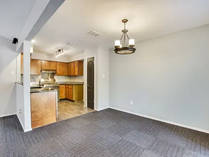a view of a kitchen with a refrigerator and a stove top oven