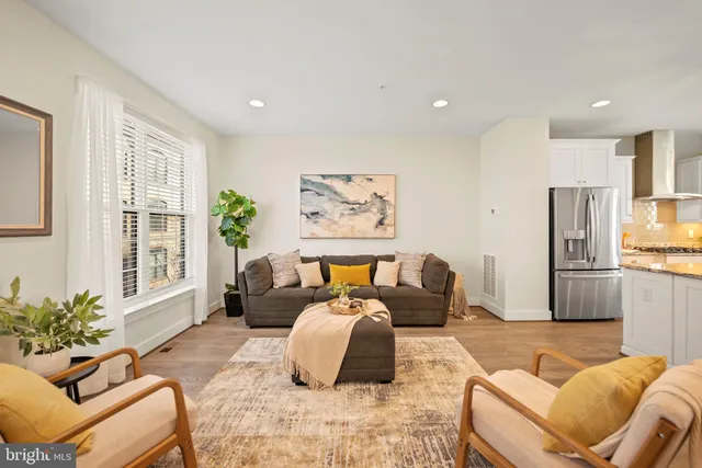 a bedroom with furniture and a large window