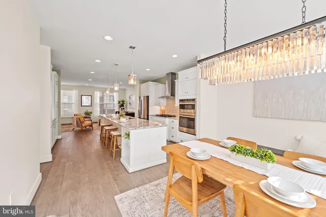 a living room with dining room and wooden floor