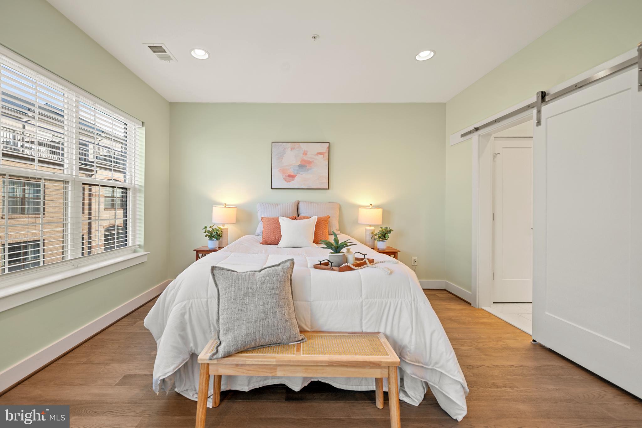 502 Windboard Way Oxon Hill, MD 20745 - Photo 20 of 54 a bedroom with a bed and wooden floor