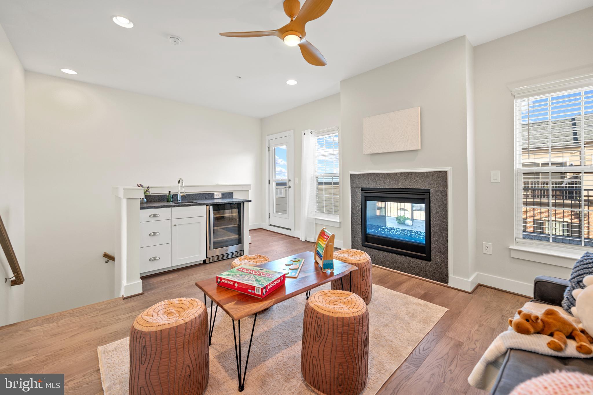 502 Windboard Way Oxon Hill, MD 20745 - Photo 30 of 54 a living room with furniture a fireplace a flat screen tv and a window