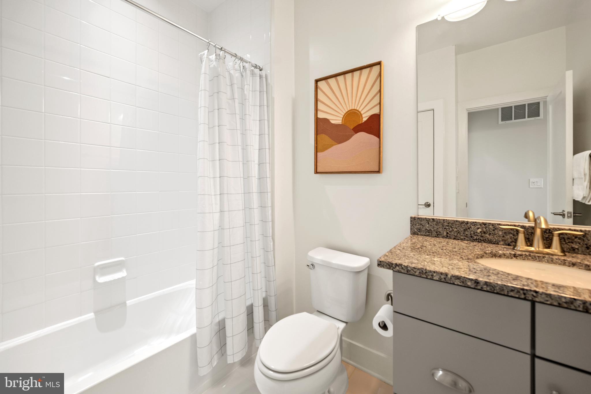 502 Windboard Way Oxon Hill, MD 20745 - Photo 32 of 54 a bathroom with a granite countertop sink a toilet and a shower