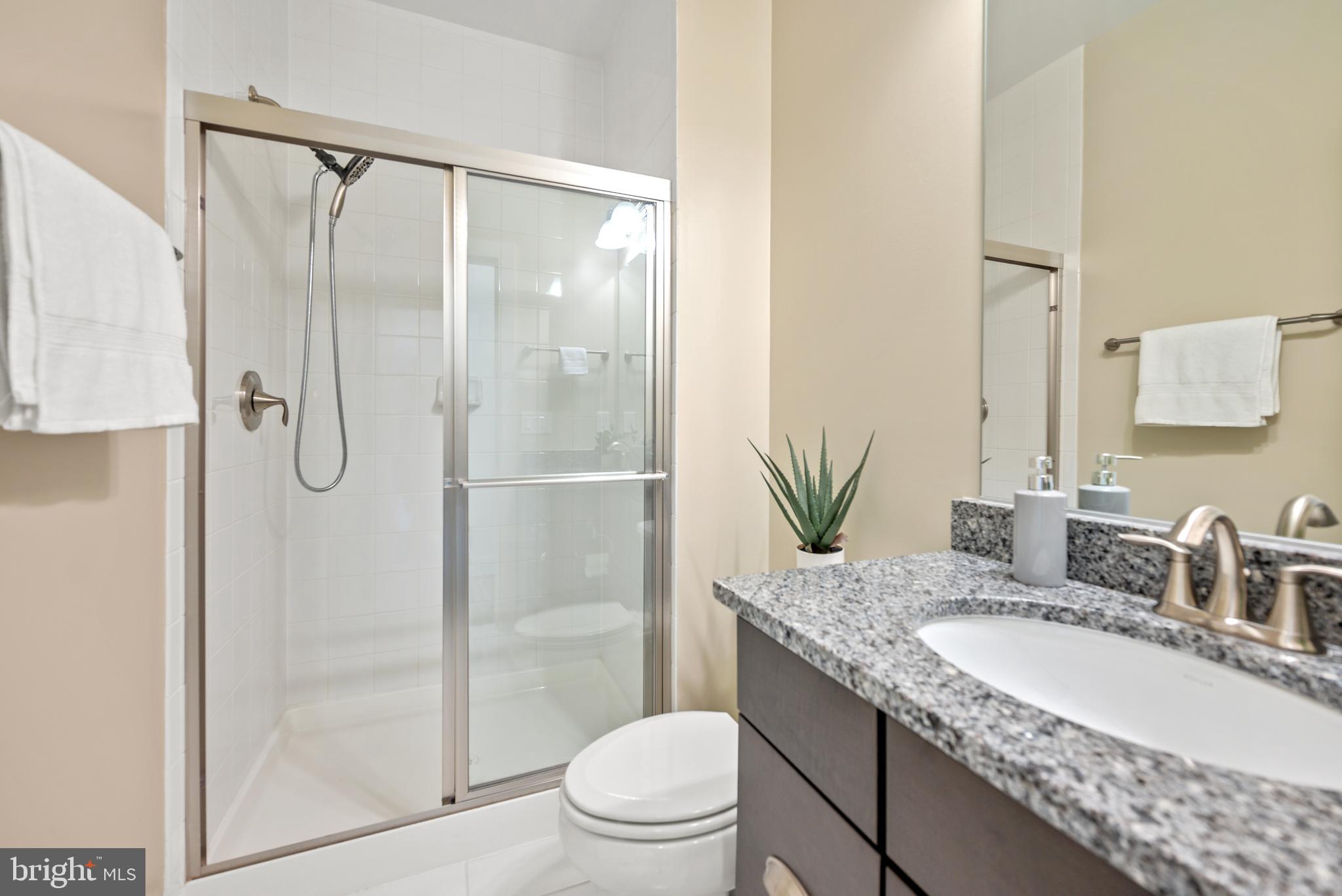 502 Windboard Way Oxon Hill, MD 20745 - Photo 44 of 54 a bathroom with a granite countertop sink toilet and shower