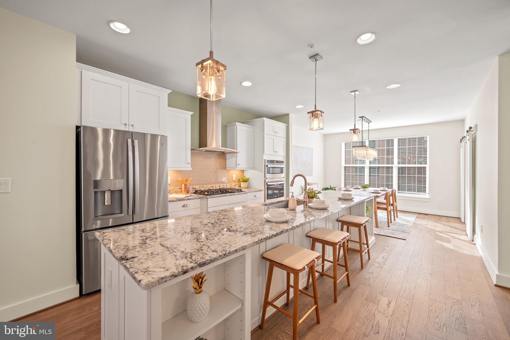 502 Windboard Way Oxon Hill, MD 20745 - Photo 6 of 54 a kitchen with stainless steel appliances granite countertop sink refrigerator and wooden floor
