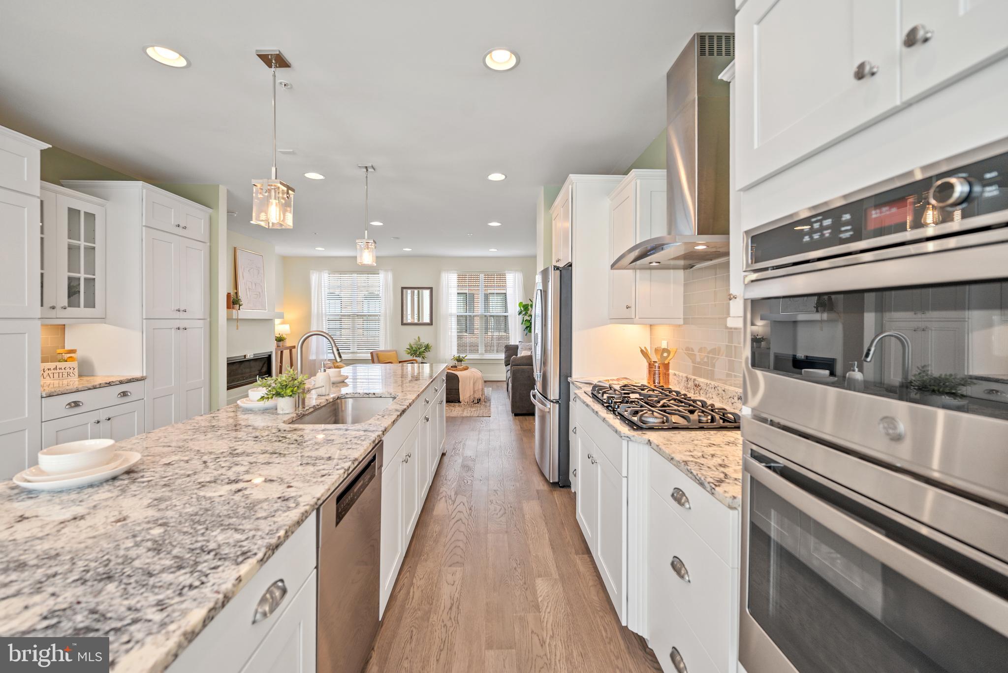 502 Windboard Way Oxon Hill, MD 20745 - Photo 7 of 54 a large kitchen with granite countertop lots of counter space and wooden floor