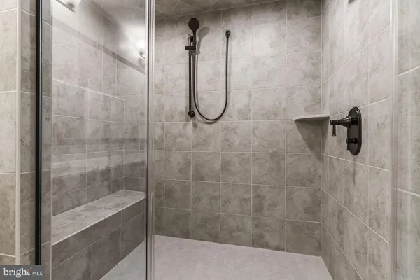 a bathroom with a glass shower door