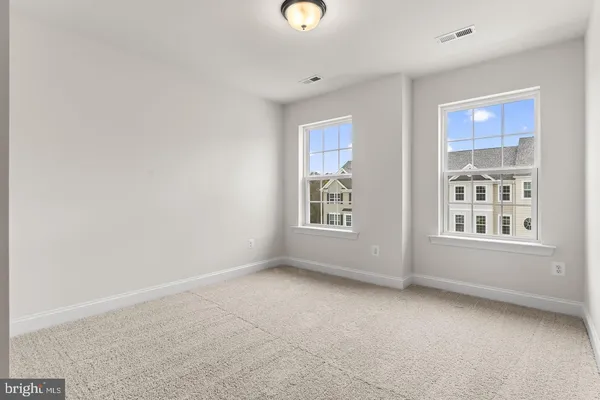 an empty room with windows and closet