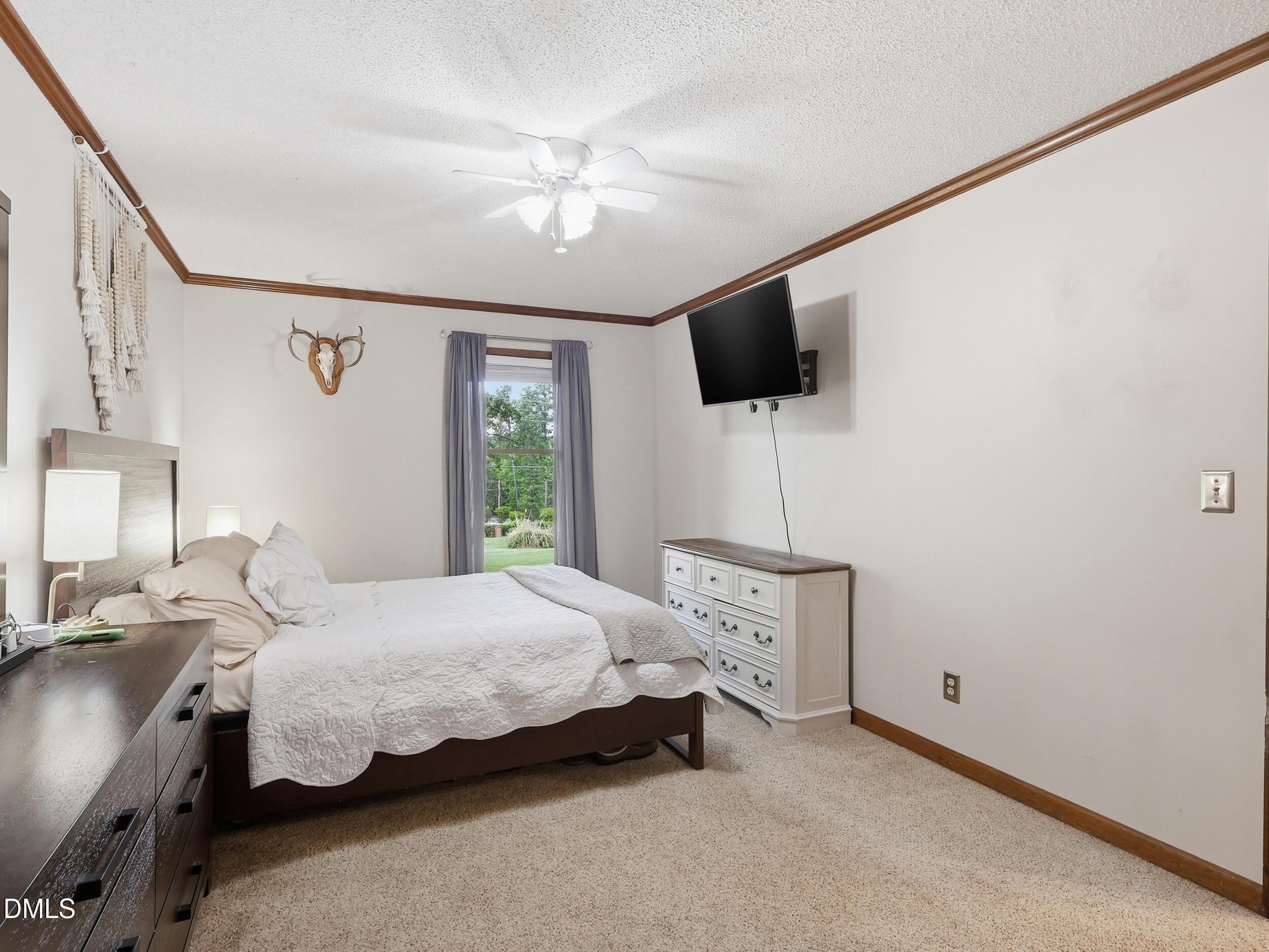517 Lake Glad Road Wendell, NC 27591 - Photo 18 of 36 a bedroom with a bed and flat screen tv