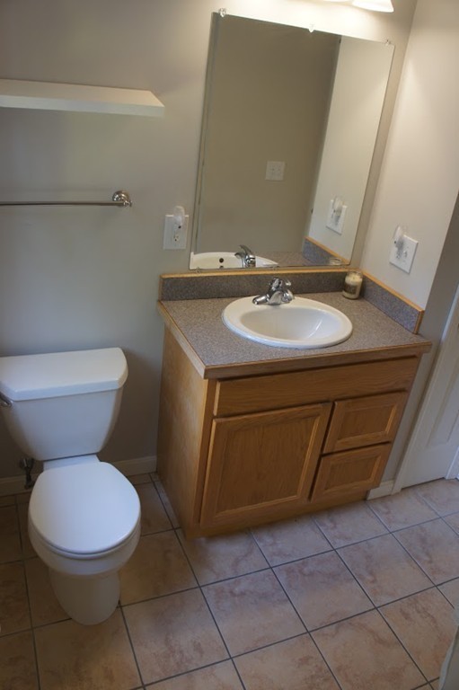 176 Palmer Road Brimfield, MA 01010 - Photo 17 of 17 a bathroom with a sink toilet and mirror