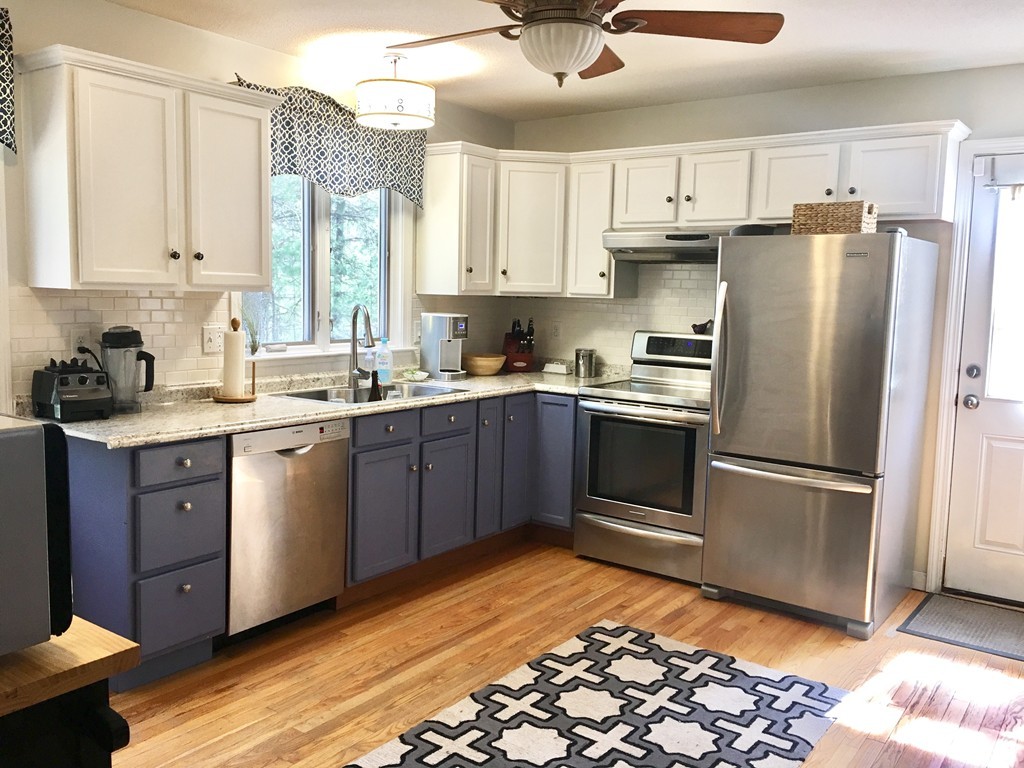 176 Palmer Road Brimfield, MA 01010 - Photo 5 of 17 a kitchen with a refrigerator sink and cabinets