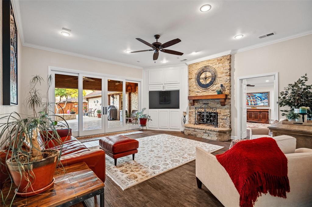 400 Hunters Ridge Circle Coppell, TX 75019 - Photo 13 of 35 a living room with fireplace furniture and a large window