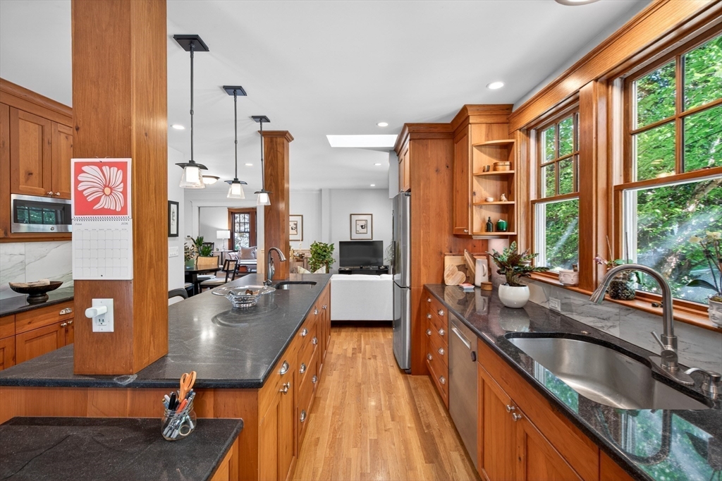 76-78 Lewis Road Belmont, MA 02478 - Photo 4 of 36 a large kitchen with kitchen island granite countertop a large window and stainless steel appliances