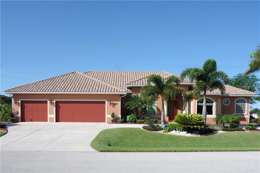 205 Tournament Road Rotonda West, FL 33947 - Photo 1 of 1 Front exterior featuring gorgeous and meticulously maintained landscaping!