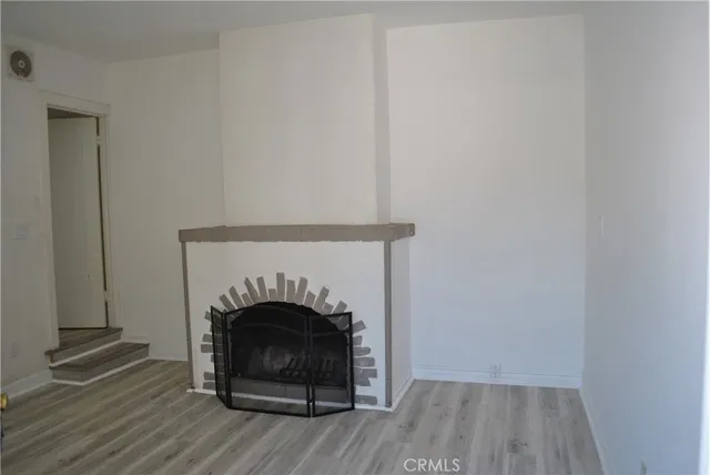 a living room with a fireplace and a wooden floor