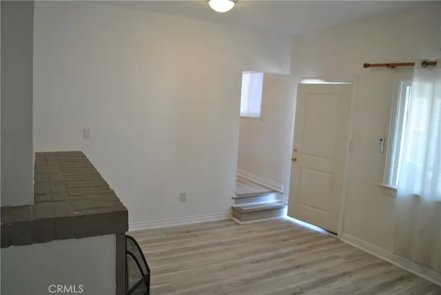 a view of wooden floor and staircase in a room