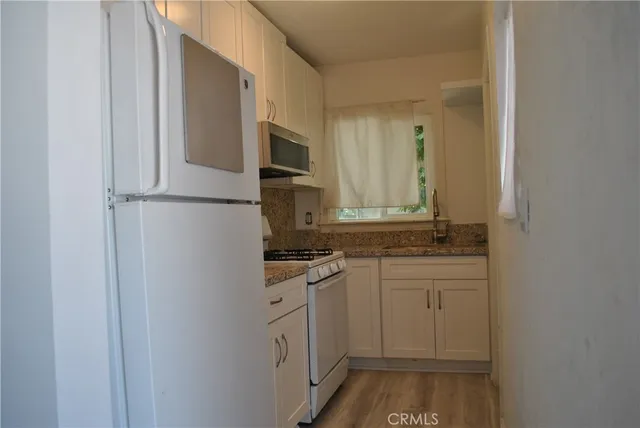 a kitchen with a sink and a refrigerator