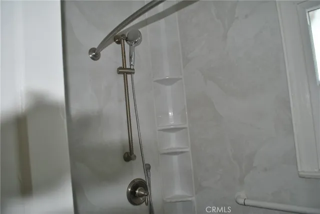 a bathroom with a glass shower door