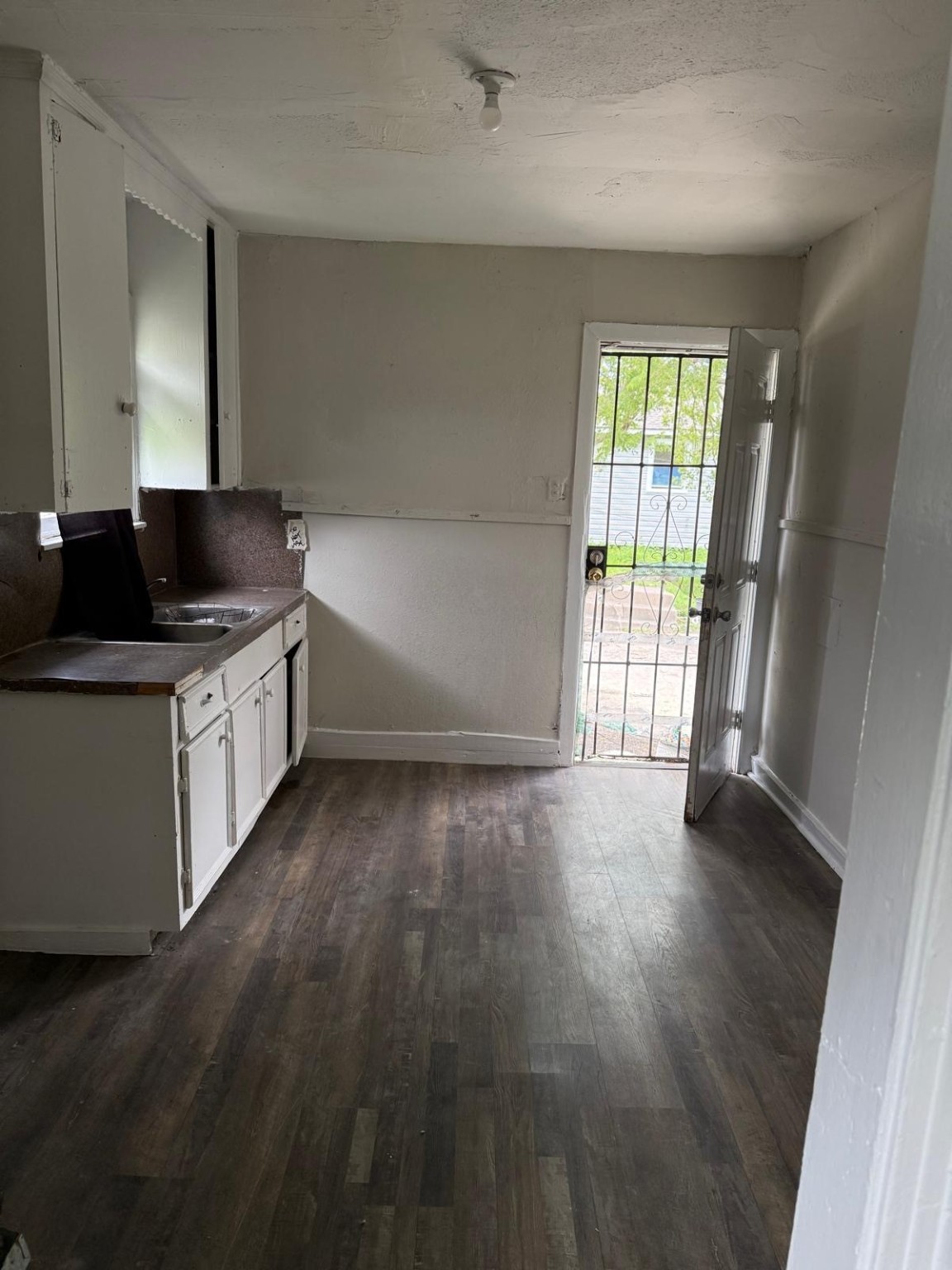 2238 Hutton Street Houston, TX 77026 - Photo 8 of 10 an empty room with wooden floor and windows