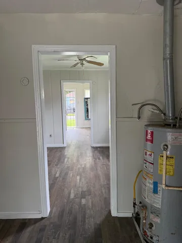 a view of hallway with livingroom and furniture