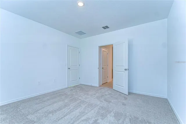 a view of an empty room and closet area