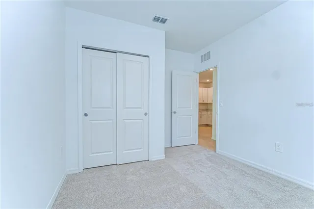 a view of an empty room and closet area