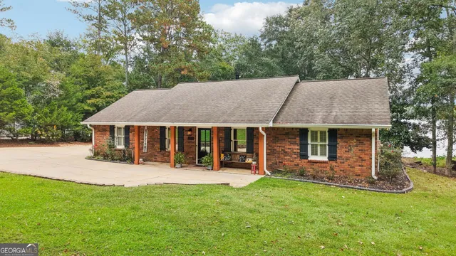 a living room with fireplace furniture and a wooden floor