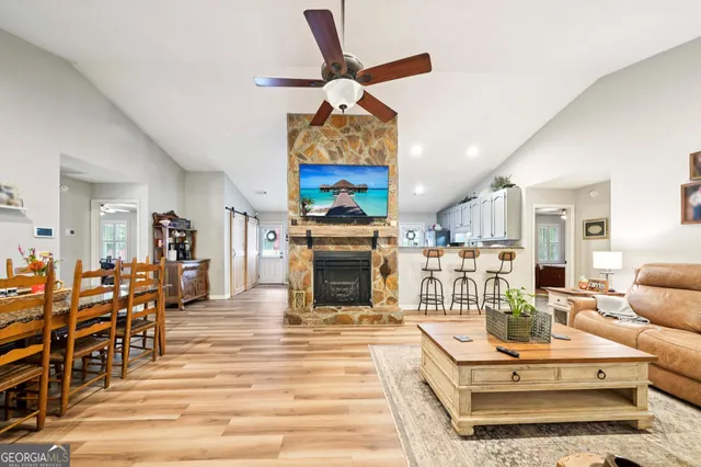 a living room with furniture a fireplace and a flat screen tv