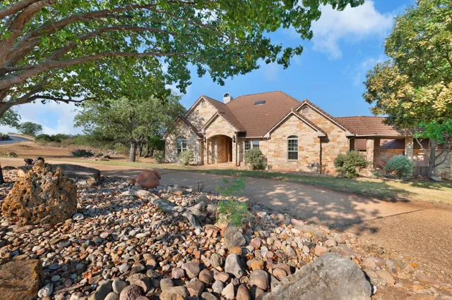 a view of a white house with a yard