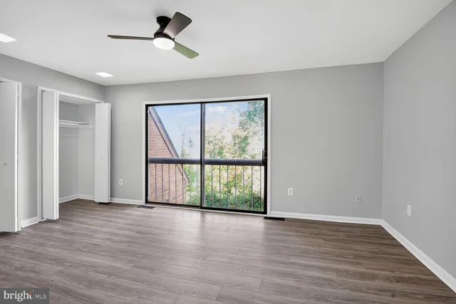 a view of room with hardwood floor and ceiling fan