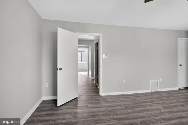 a view of an empty room and wooden floor