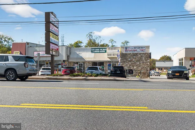 a view of a house with a cars park on the road