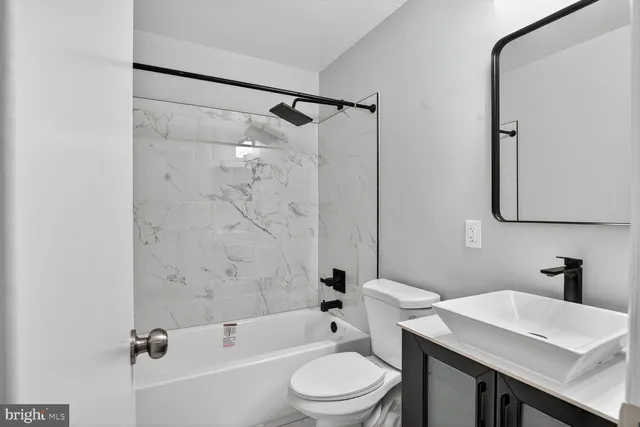 a bathroom with a sink a toilet and a bathtub