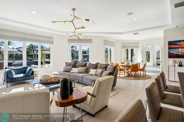 a living room with lots of furniture and a chandelier