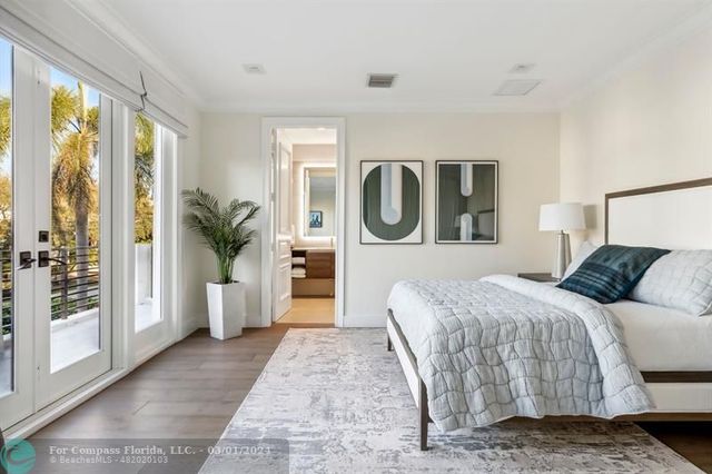 a bedroom with a large bed and a window