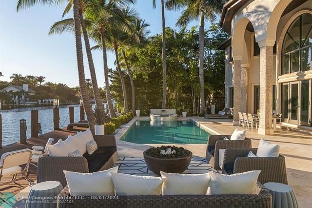 a view of a patio with couches chairs and a fire pit