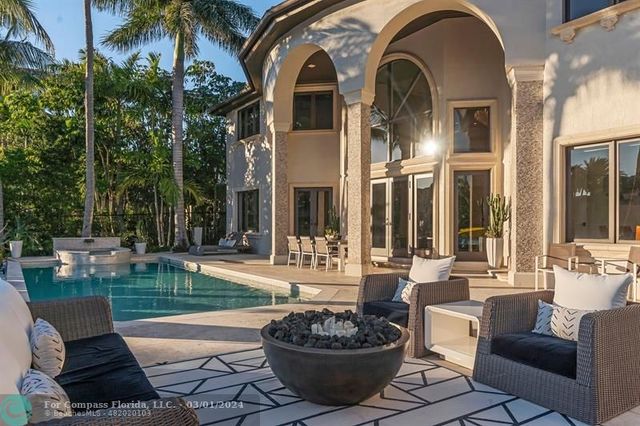 a view of a patio with a dining table and chairs