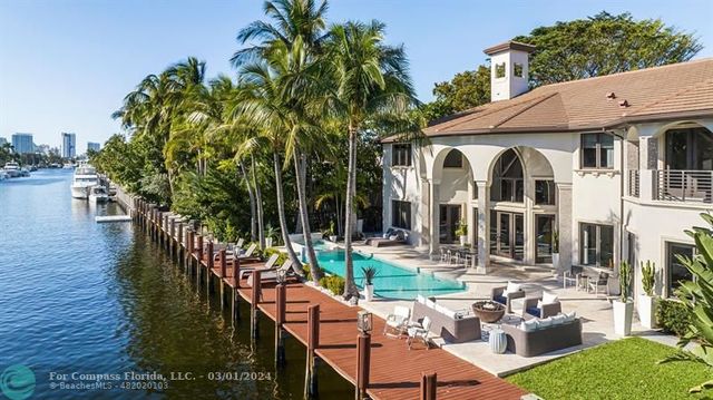 a view of a patio with couches table and chairs and potted plants