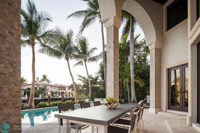 a view of a balcony with lake view and a palm tree