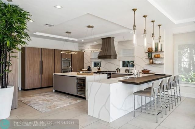 a kitchen with appliances a sink and cabinets
