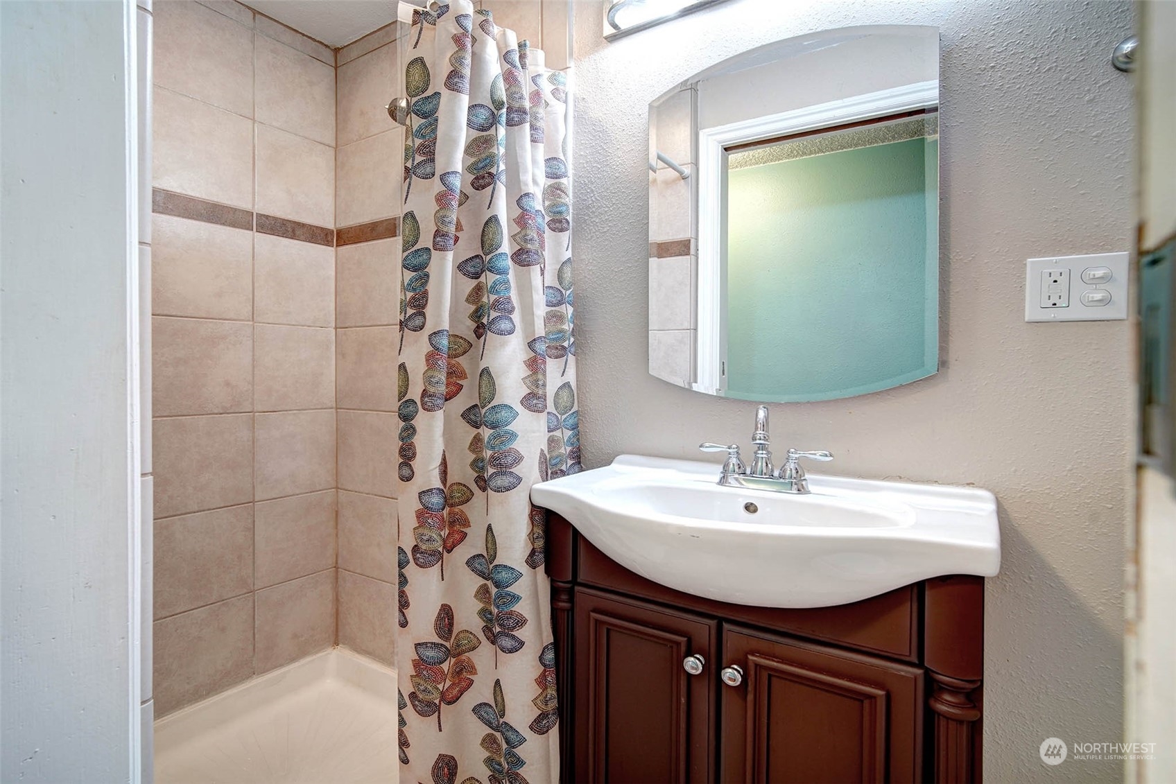 21711 6th Avenue West Bothell, WA 98021 - Photo 7 of 10 a bathroom with a sink a mirror and shower