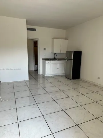 a kitchen with cabinets and a stove top oven