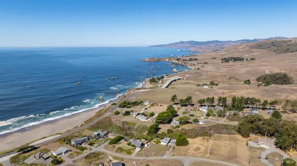 a view of an ocean beach and mountain