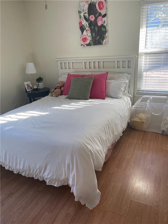 1106 West 22nd Street, Unit 3 Austin, TX 78705 - Photo 4 of 5 a bedroom with bed and wooden floor