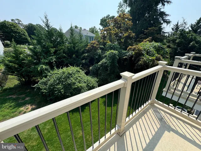 a view of balcony with deck and trees