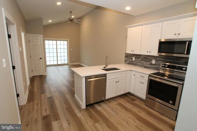 a kitchen with a sink stove and microwave