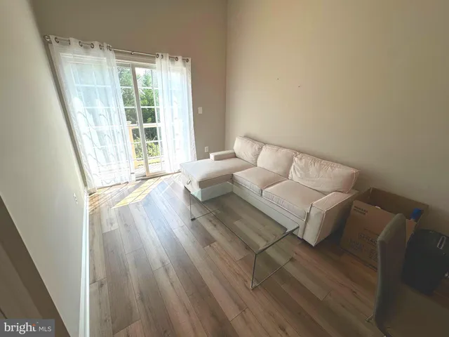 a living room with couch and wooden floor