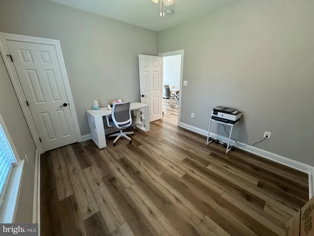 a room with wooden floor and furniture